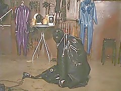 Slut in rubber zips herself in rubber sack